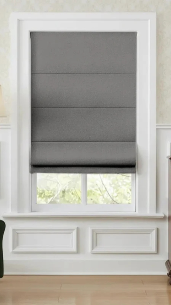 Modern gray Roman shade for bedroom window with clean white trim