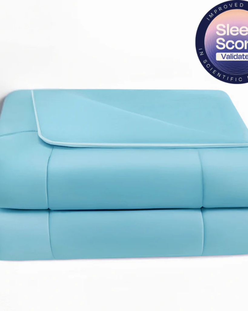Luxury cooling comforter folded on a bed, designed for soft breathable comfort and restful sleep