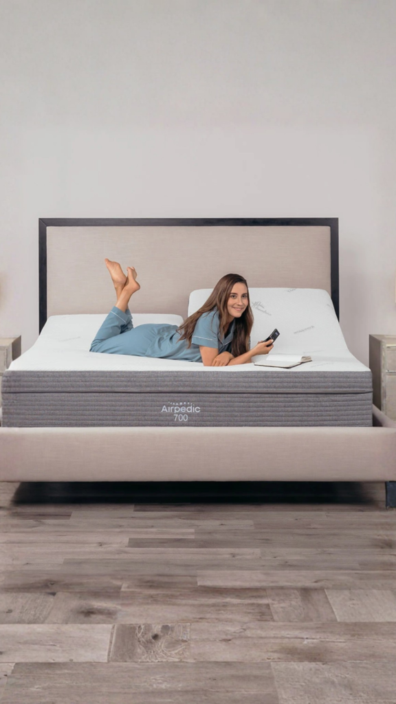 Airpedic adjustable mattress with woman relaxing in bed illustrating signs it’s time to replace your mattress