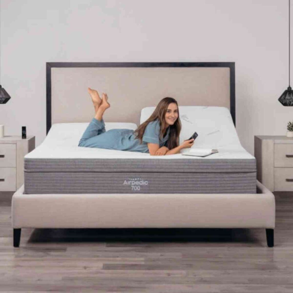 A woman lying comfortably on an Airpedic air mattress, demonstrating the deep pressure relief and contouring support for a restful night.