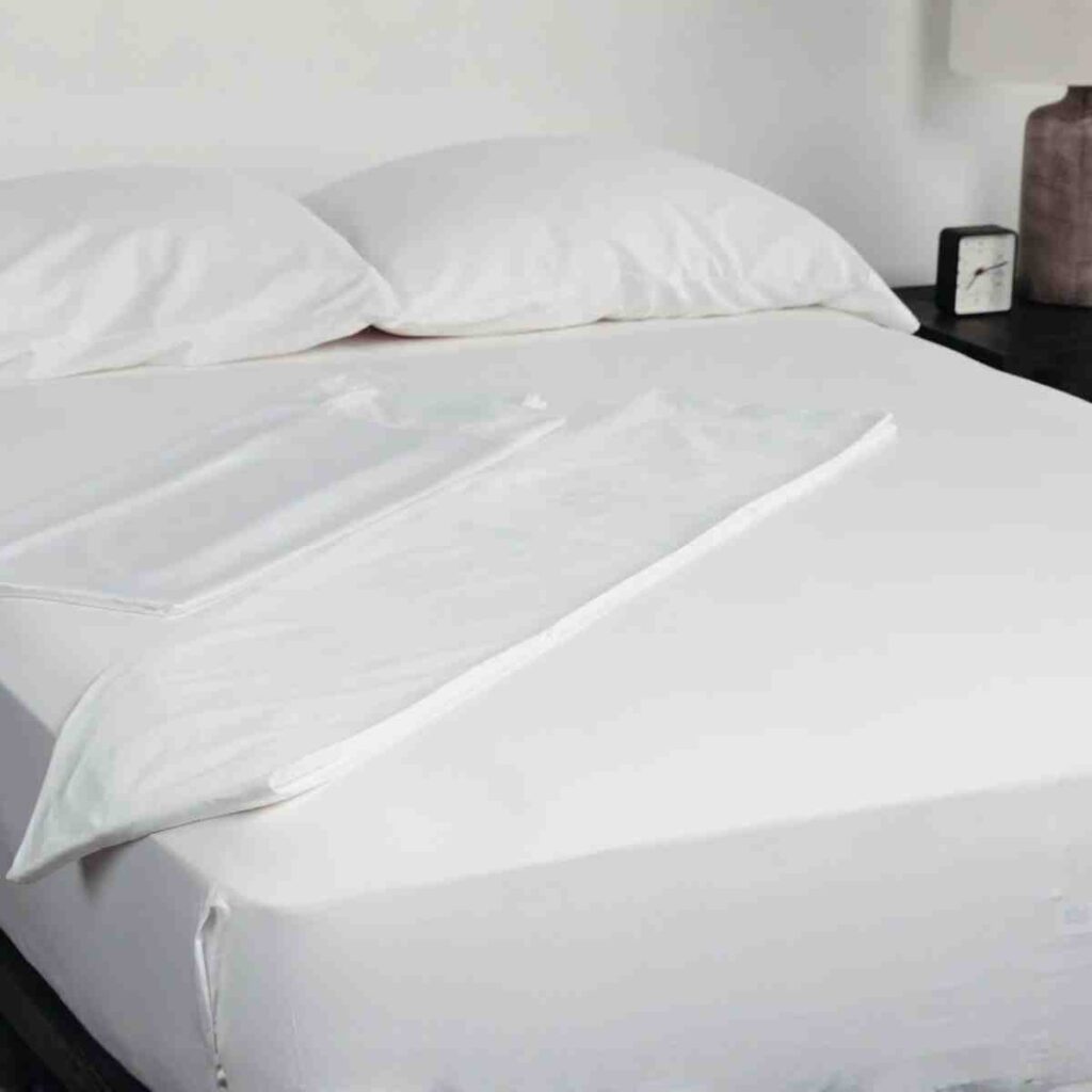 Close up of white Airpedic luxury bamboo sheets on a made bed, highlighting the soft, breathable fabric texture.
