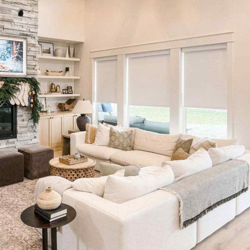 Modern white custom blackout roller shades installed in a bright, contemporary living room for total light control.
