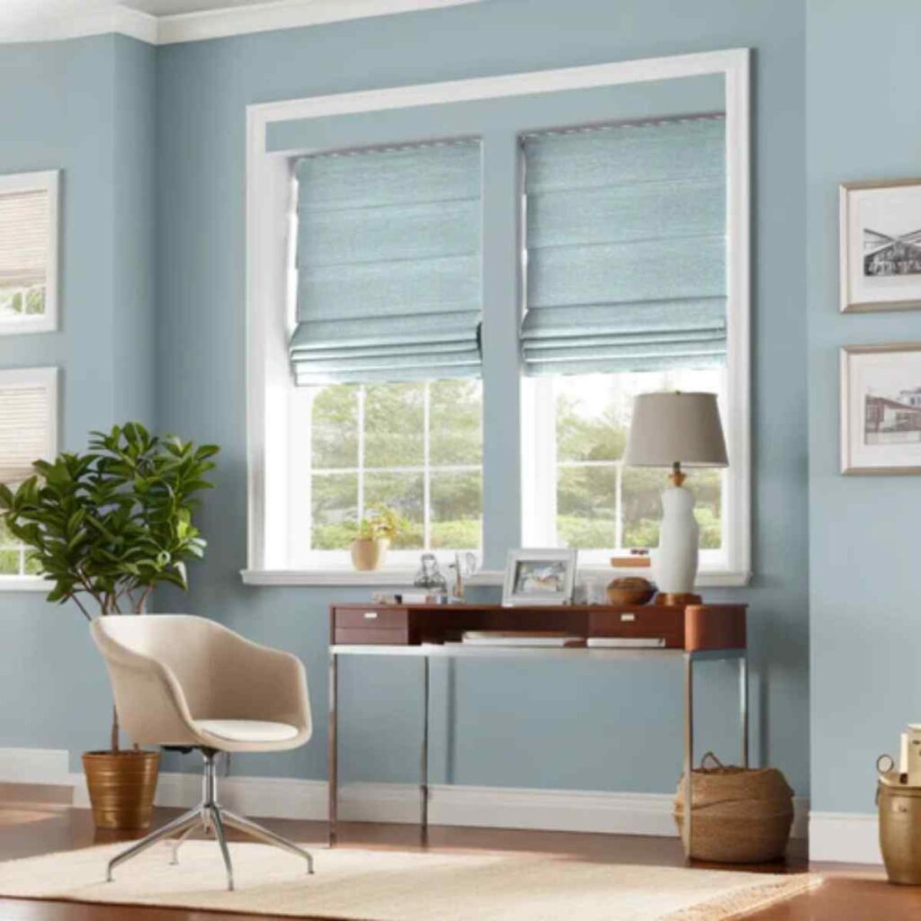Premium quality light blue CurtainUK Roman shades in a home office providing tailored style and excellent light control.