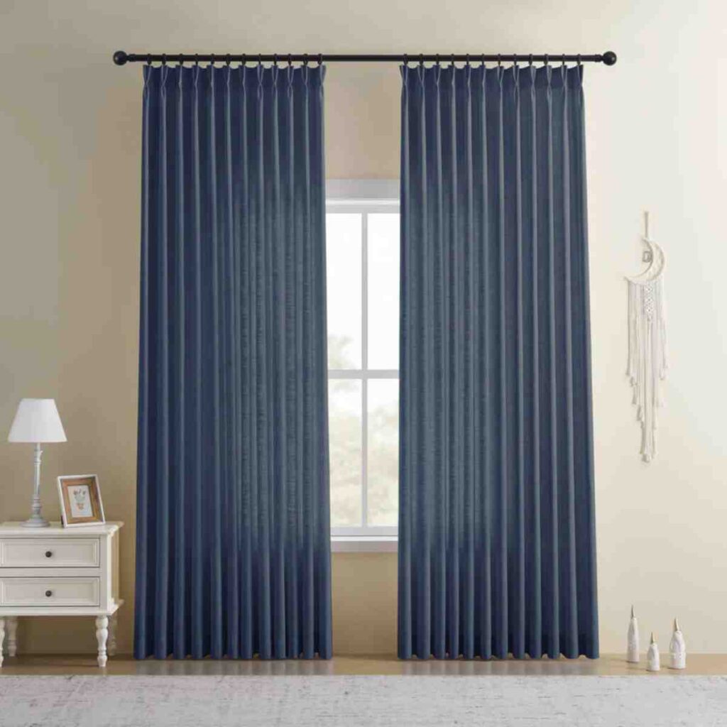 Deep navy blue linen-blend curtains framing a bedroom window with white furniture.