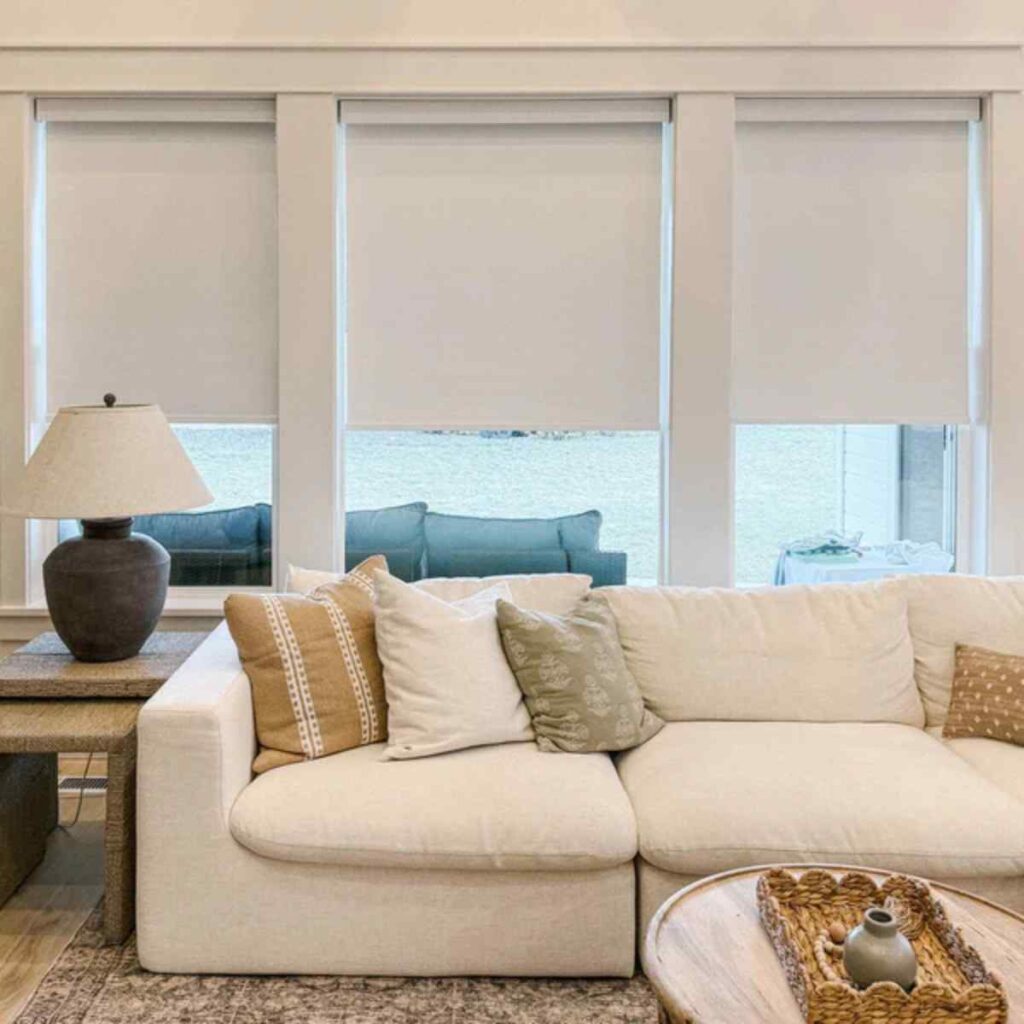 urable cream-colored CurtainUK roller bliDurable cream-colored CurtainUK roller blinds in a bright living room offering a minimalist look and total privacy.nds in a bright living room offering a minimalist look and total privacy.