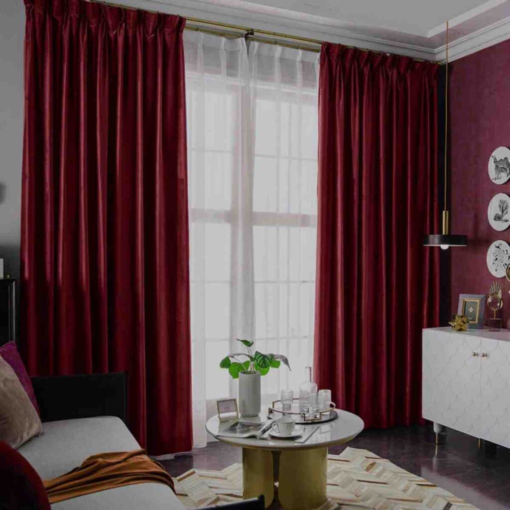 Deep burgundy modern velvet curtains by CurtainUK in a high-contrast luxury living room.