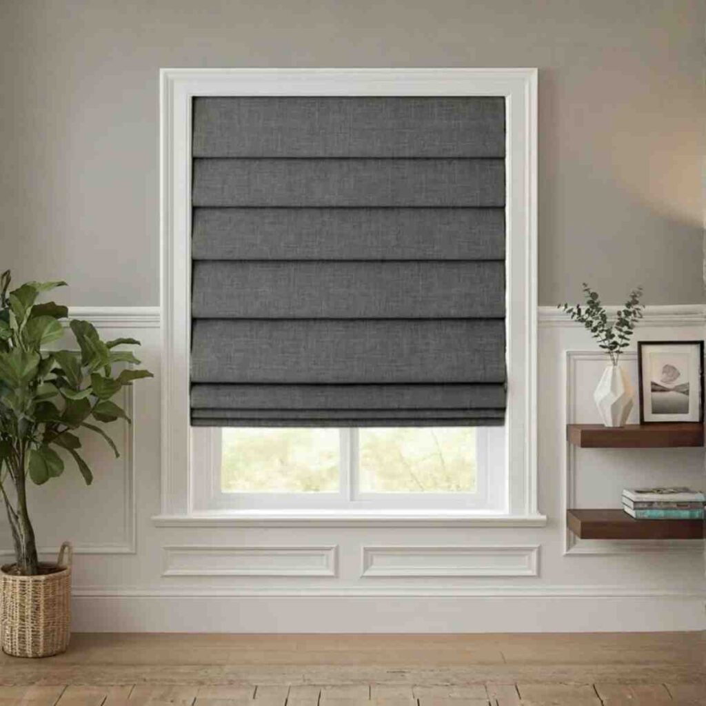 A grey custom blackout Roman shade by CurtainUK installed in a minimalist bedroom window.
