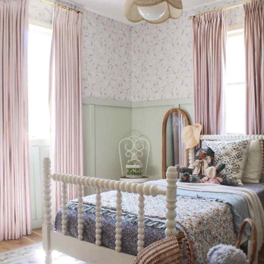 Soft pink tailored blackout curtains in a child’s nursery, providing 100% light blockage for sleep.