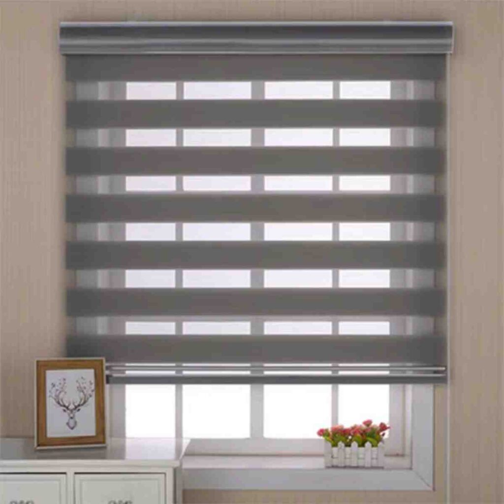 Modern grey and white zebra-style dual shades by CurtainUK installed in a bright room.