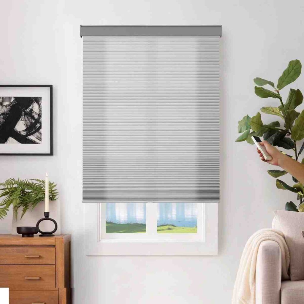 Joydeco cordless motorized light-filtering cellular shade in grey for easy remote operation.