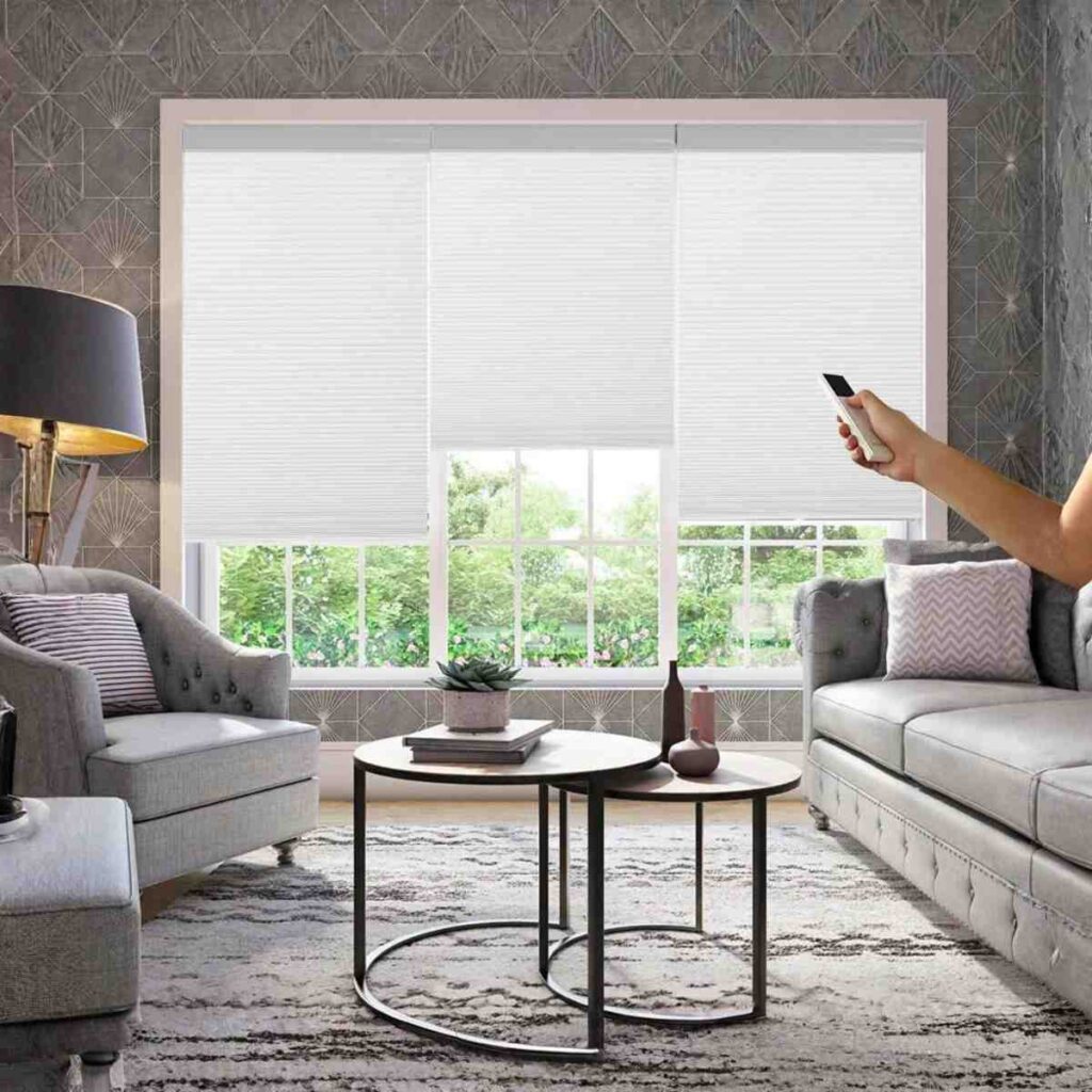 Joydeco cordless motorized light-filtering cellular shade in white for modern window decor.