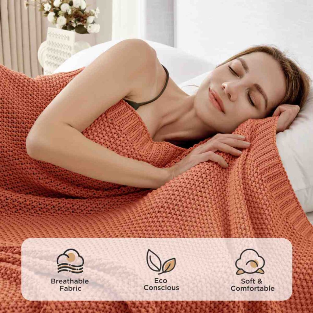 A woman sleeping comfortably under a breathable Joydeco rust orange chunky knit throw.