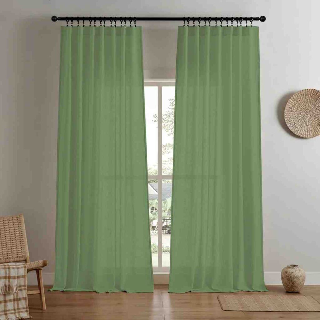 Joydeco sage green light-filtering linen curtain in a sunny and minimalist room.