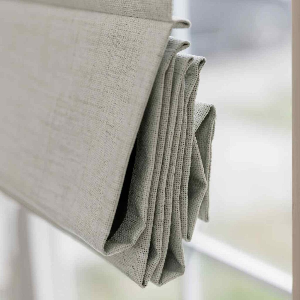 Close up of Joydeco Roman shade fabric showing the stackable pleats and texture.