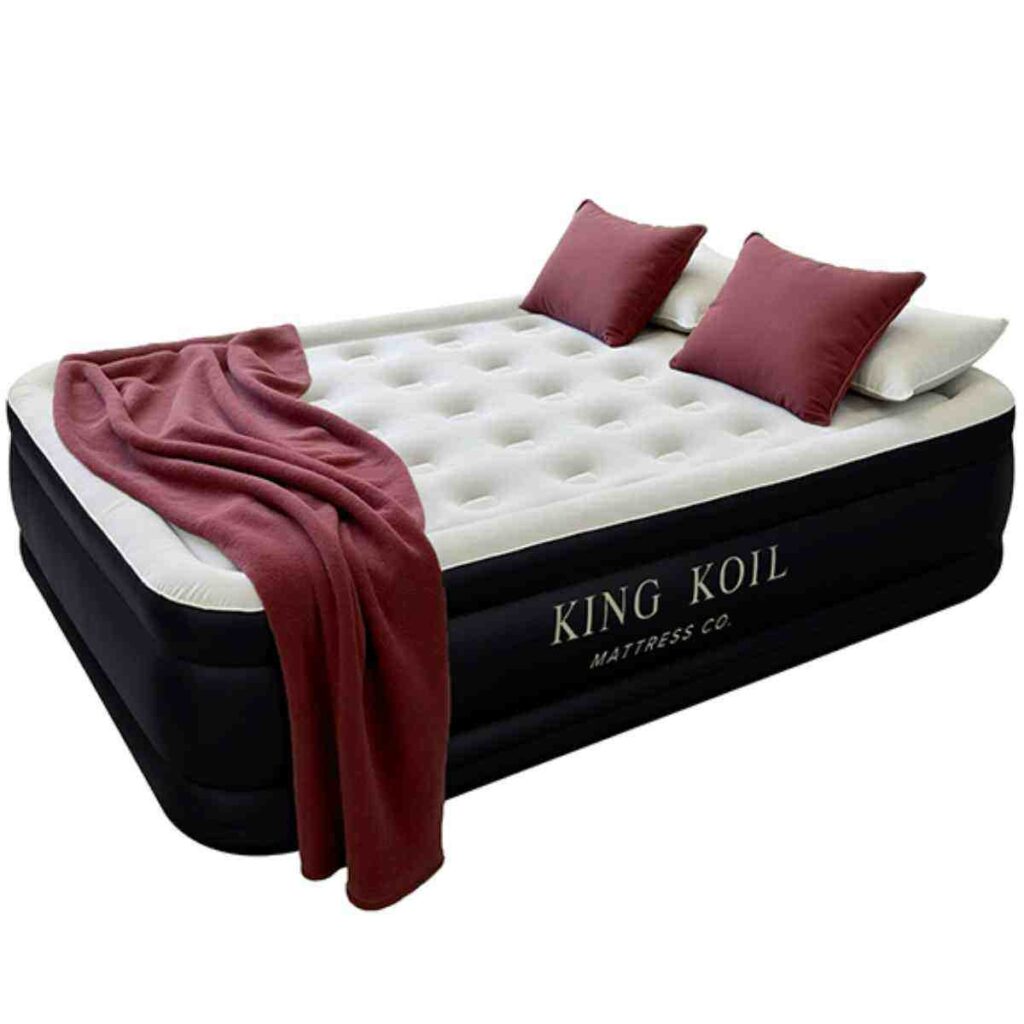 Black and grey King Koil air mattress with a red throw blanket.