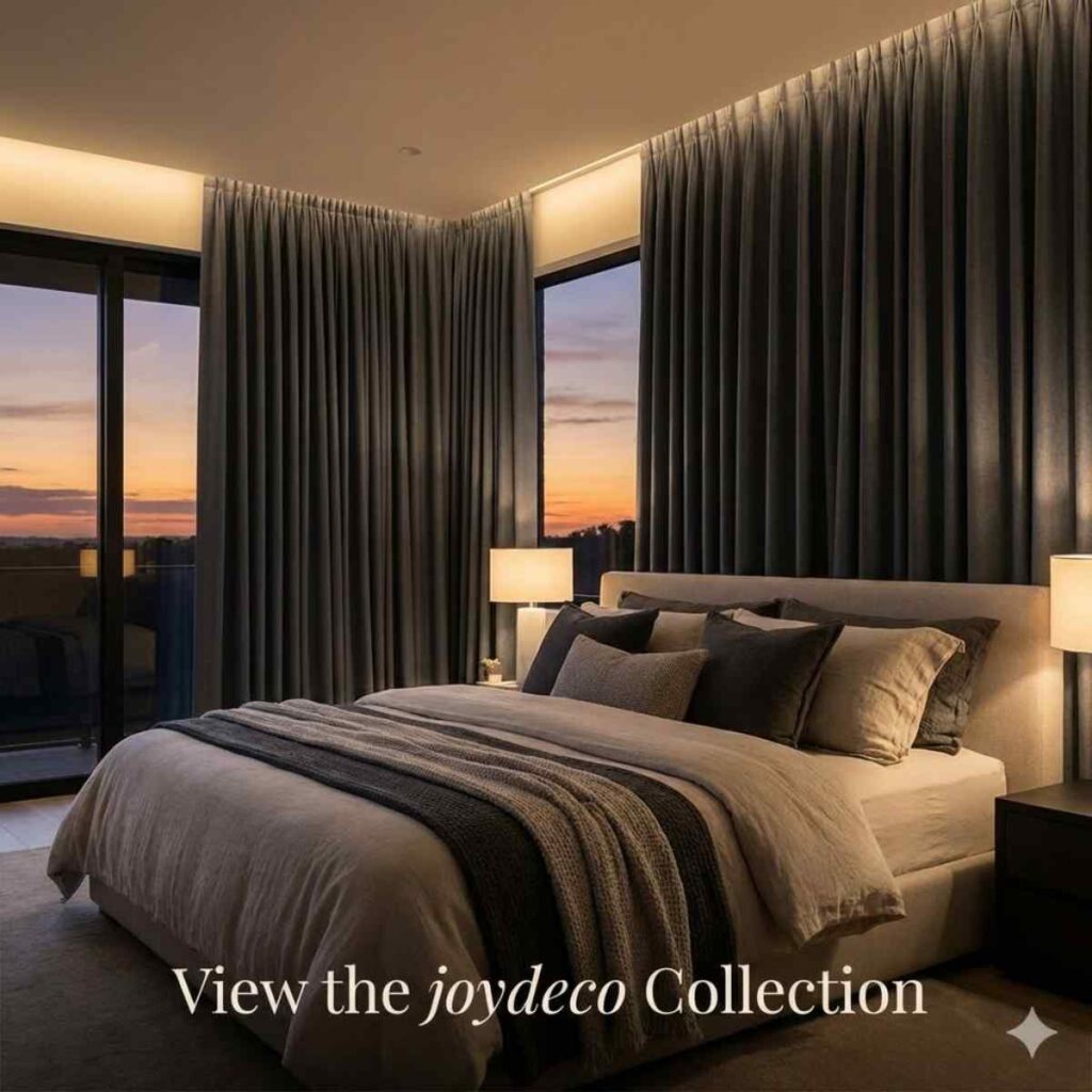 Luxury master bedroom featuring premium charcoal grey blackout curtains partially closed at sunset, showcasing the Joydeco sanctuary collection.