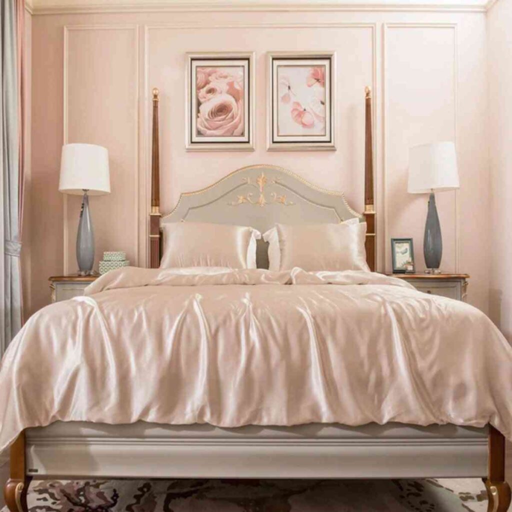 Elegant Promeed silk bed sheets in a neutral champagne tone, showcasing the smooth satin-style texture on a luxury bed frame.