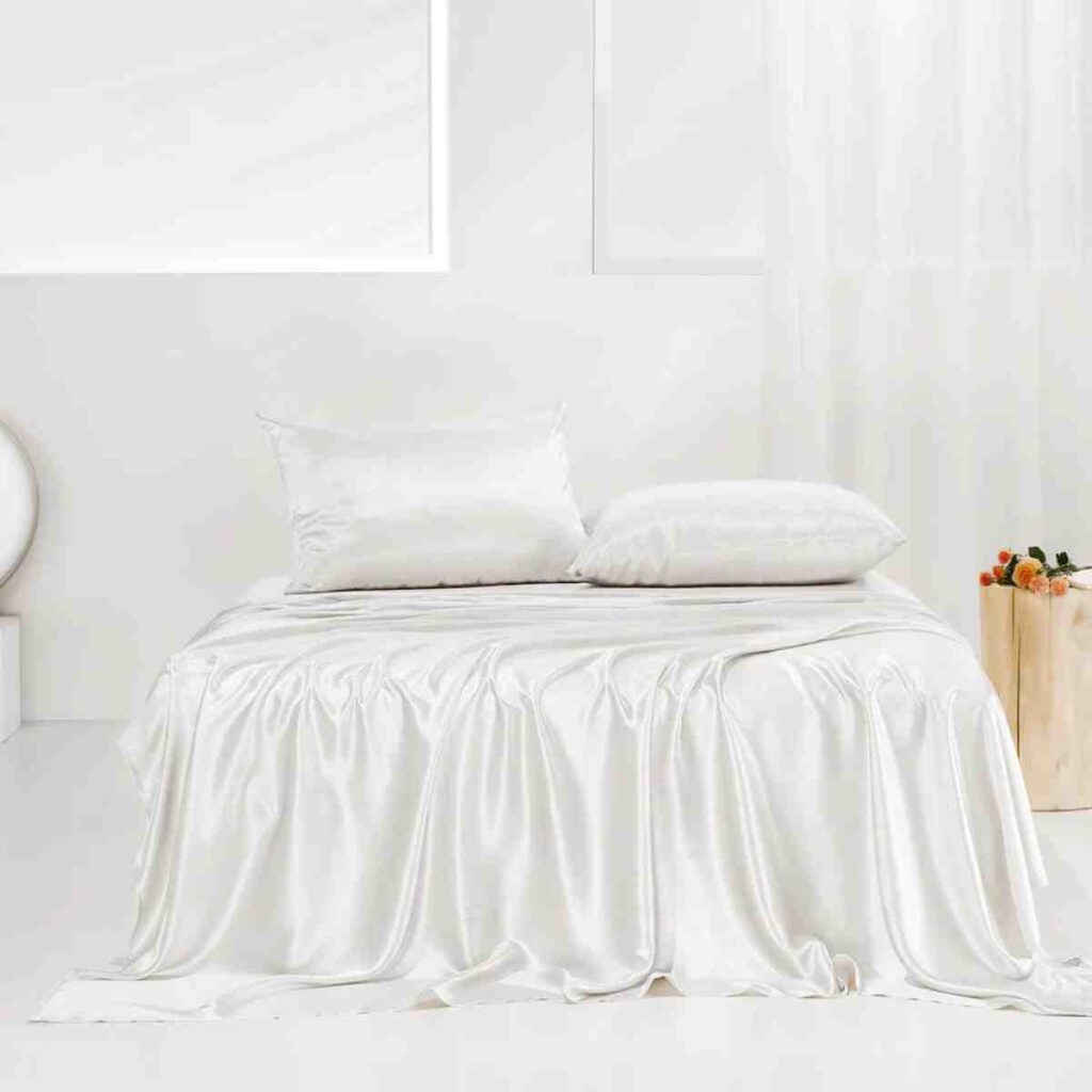 All-white Promeed silk bedding set showcasing a smooth, luminous finish.