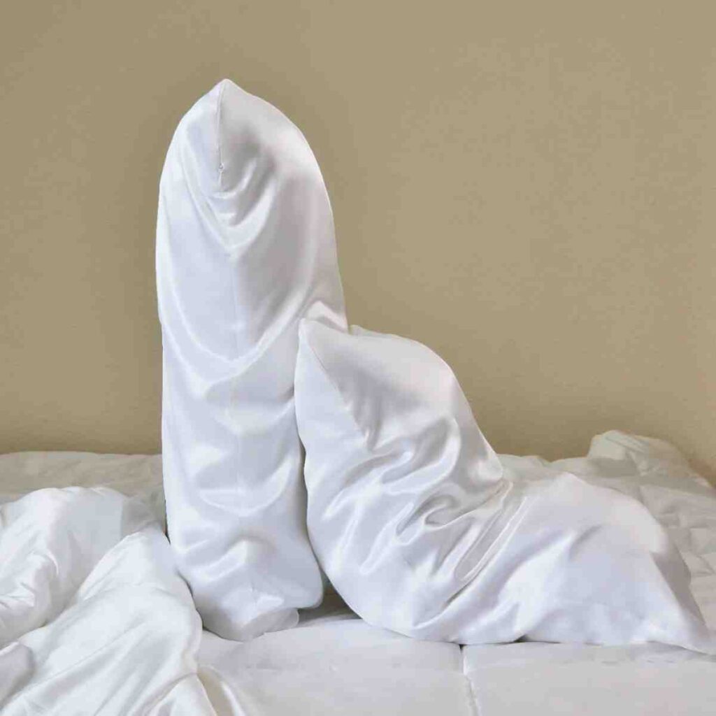 Close-up of a white Promeed silk pillowcase showing the fabric's sheen.