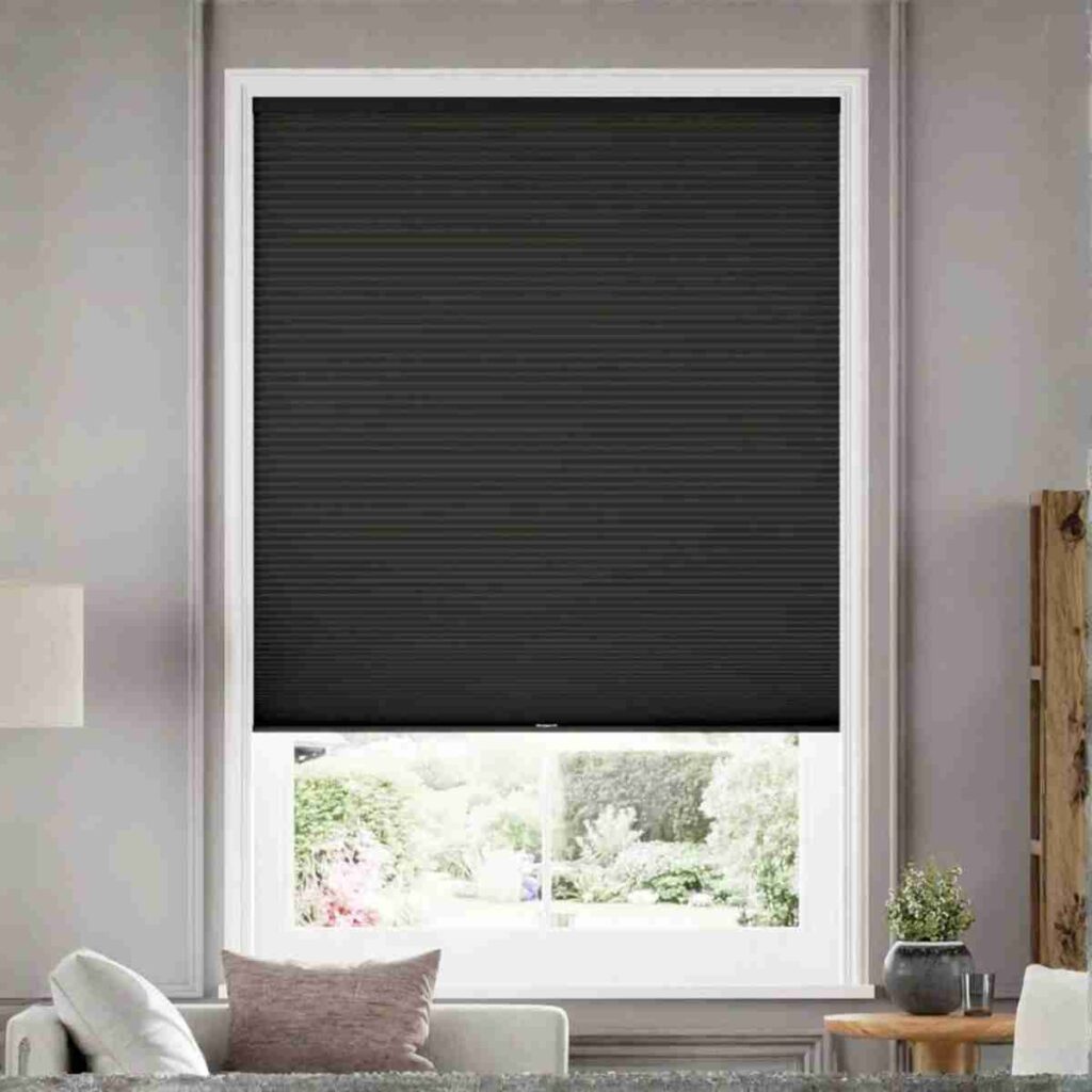 Buy Joydeco Black Cordless Cellular Shades Joydeco Black Custom Cordless Blackout Cellular Shades in a modern, dark bedroom.