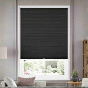 Joydeco Black Custom Blackout Cordless Cellular Shades in a modern, dark bedroom.