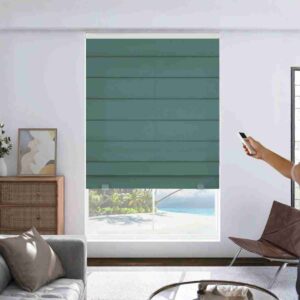 Joydeco hunter green blackout motorized roman shades partially closed in a modern white living room, showing the cordless, remote-controlled design.