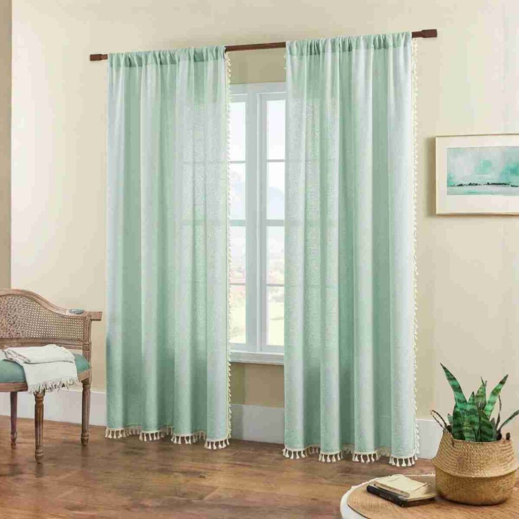 Shop Joydeco Light Green Boho Curtains Joydeco light green boho sheer curtain with decorative tassel edges.