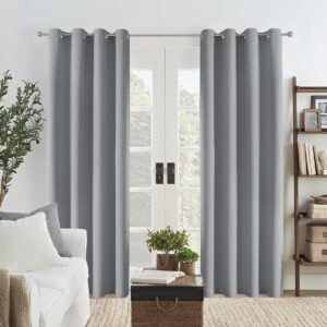 Pair of elegant light grey linen curtains with silver grommets framed around a white French door in a bright, modern living room setup.