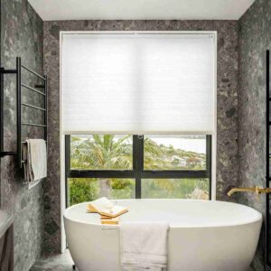 Light Filtering Cellular Shades by Joydeco: a custom honeycomb window treatment in a modern bathroom