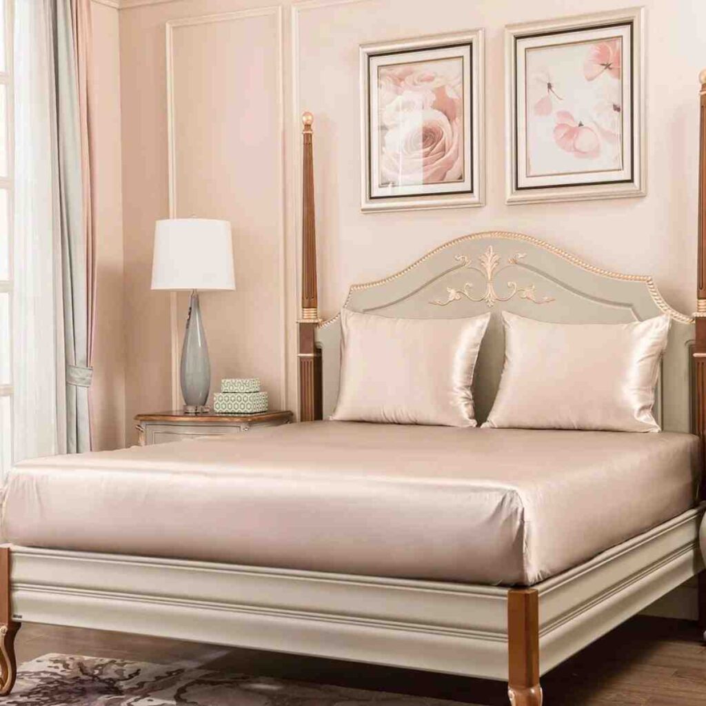 Promeed Gold Luxury silk bedding  fitted sheets over an elegant bed frame