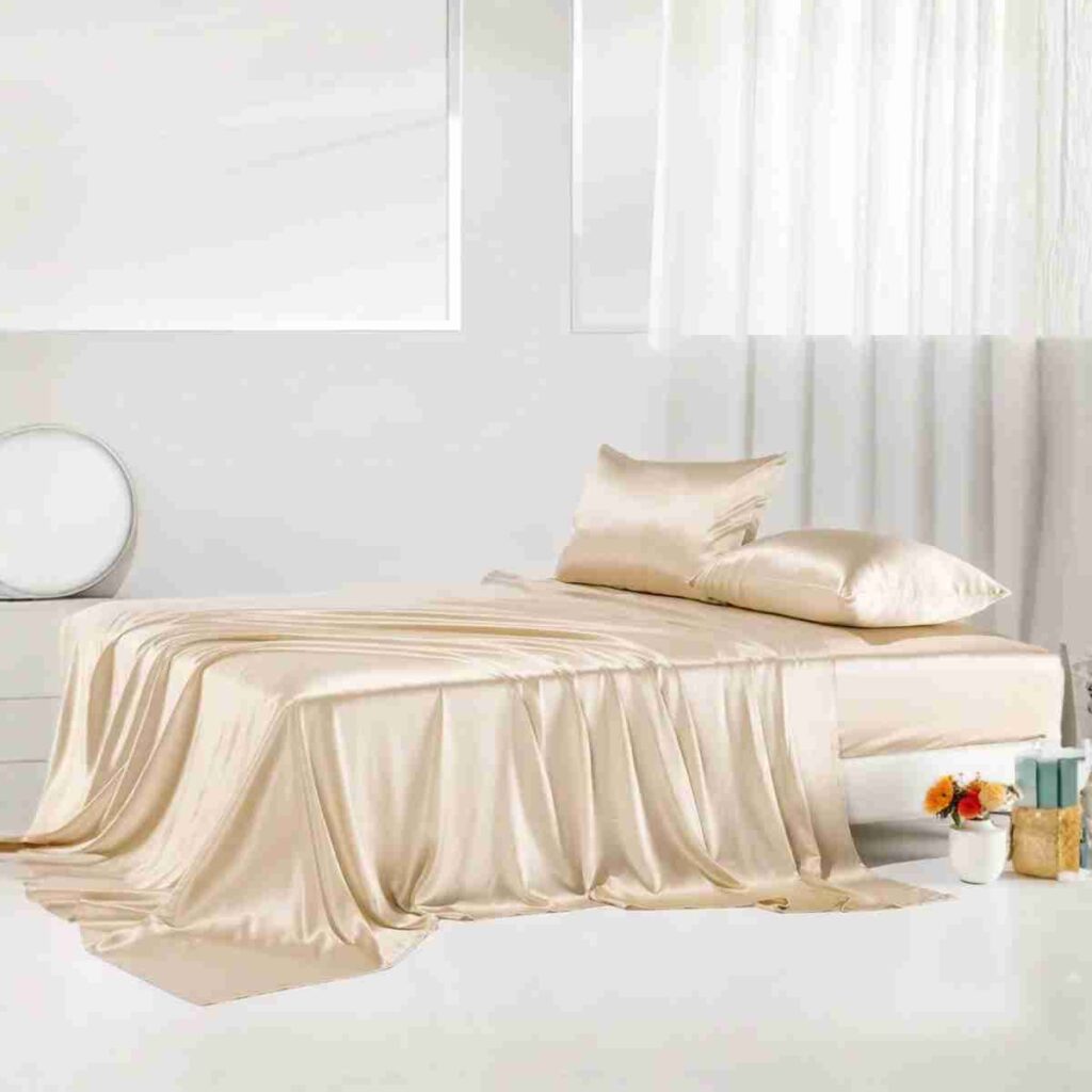 Promeed gold silk flat sheet set in a soft luxury bedroom setting
