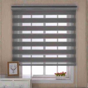 Modern waterproof gray zebra shades with alternating sheer and solid gray stripes installed on a window above a white cabinet.