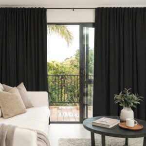 Joydeco tailored window treatment presentation highlighting premium alder black curtain setup over a clean living room setting.