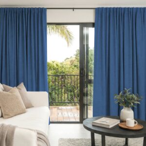 Sleek architectural living zone showcasing how an integrated alder navy blue curtain setup filters intense direct afternoon solar rays.