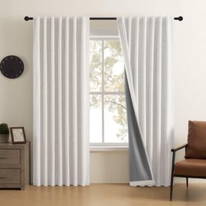 Close-up fabric details highlighting a high-quality set of greyish white blackout curtain draped in a modern bedroom.