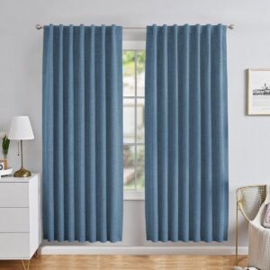 A perfectly styled layout showing sky blue blackout curtains hanging by a window in a contemporary interior.