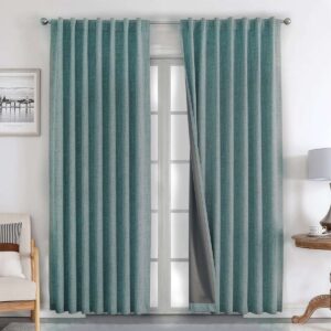 Elegant drapery style exhibition accenting the heavy texture of hunter green blackout curtains near a cozy corner.