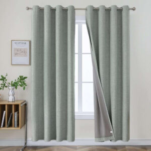 Close-up fabric details highlighting a high-quality set of sage green linen curtains draped in a modern bedroom.