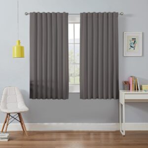 Elegantly draped window display focusing on the clean lines of grey blackout curtains framing a scenic backyard view.