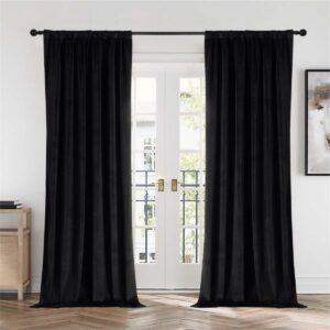 Elegant drapery style exhibition accenting the heavy texture of black velvet blackout curtains near a cozy corner.