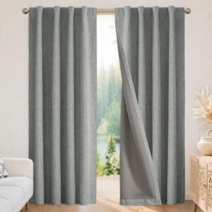 Nicely decorated corner nook highlighting the soft light-filtering weave pattern of a custom-hung light grey thermal curtains.