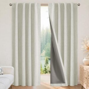 A modern well-appointed residential space showcasing functional light beige thermal curtains installed cleanly over a window frame.