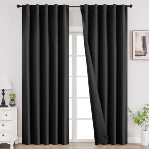 A modern well-appointed residential space showcasing functional black long bedroom curtains installed cleanly over a window frame.