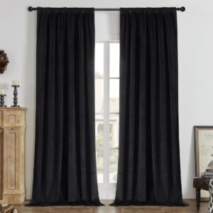 A perfectly styled layout showing black blackout curtains hanging by a window in a contemporary interior.