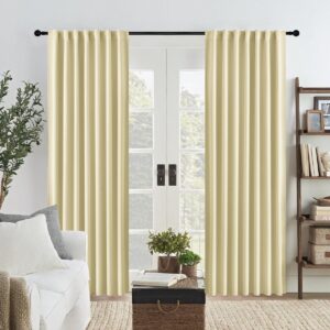 Beautifully arranged apartment interior featuring the clean straight hang of a premium blackout curtains light beige set.