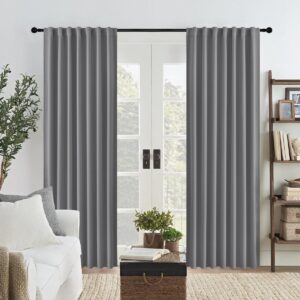 A peaceful master suite window setting showcasing high-quality blackout curtains light grey drawn neatly together.