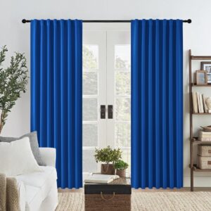 Beautifully arranged apartment interior featuring the clean straight hang of a premium blackout curtains royal blue set.