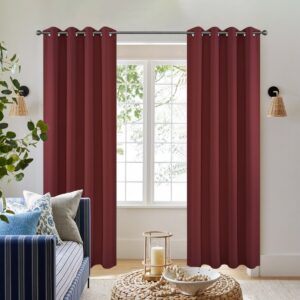 Pair of joydeco blackout burgundy red thermal insulated long drapes by Joydeco hanging in a bright modern bedroom.
