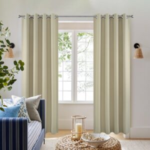 Pair of joydeco blackout light beige thermal insulated long drapes by Joydeco hanging in a bright modern bedroom.