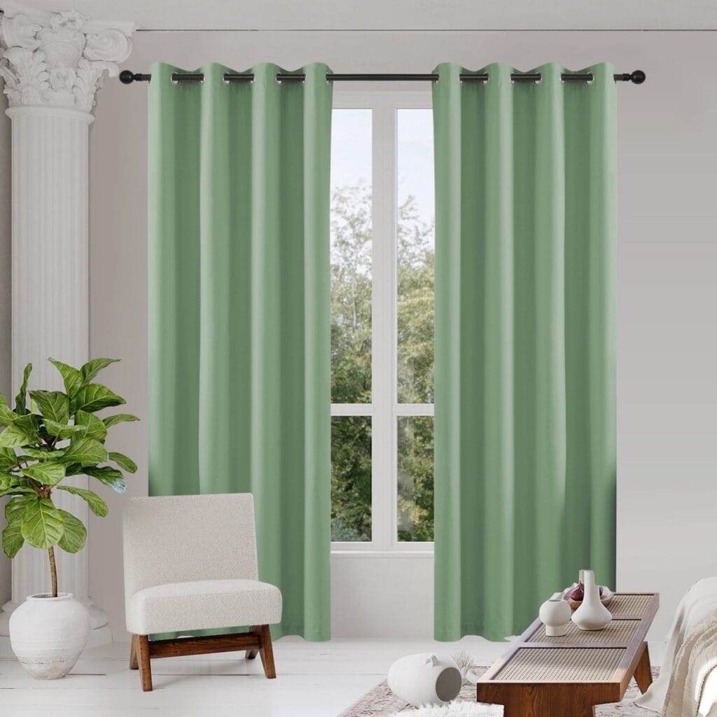 Sleek residential window frame showing how an integrated pair of sage green blackout curtains blocks street glare perfectly.